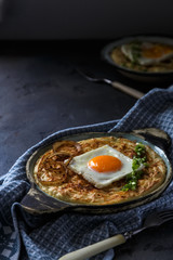 Thick mashed potatoes with sunny side egg, copy space.