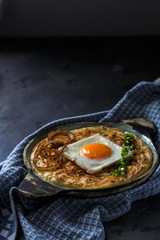 Thick mashed potatoes with sunny side egg, copy space.