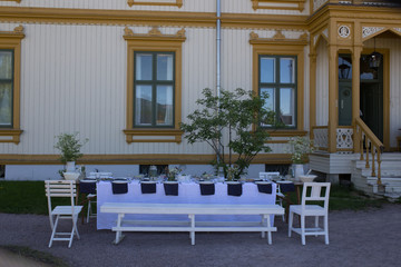 Table for outside dining in front of gorgeous house