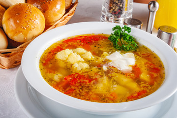 Vegetable soup with cauliflower in white bowl. Close up