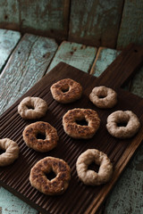 Obraz na płótnie Canvas Homemade hygge sweets. Small wholegrain vegetarian cookies on oak board on shabby blue background