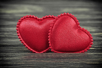 Valentines day concept. Two red heart on dark wooden background.