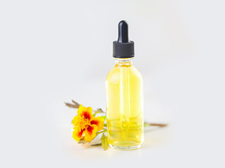 Obraz na płótnie Canvas marigold essential oil in beautiful bottle on White background