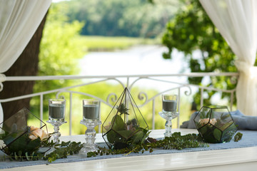 Florarium with fresh succulent and rose flowers festive table decoration. Event fresh flowers decoration. Florist workflow. Wedding ceremony  design