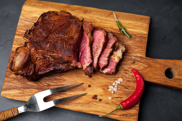 delicious steak, seasonings, a delicious piece of meat, cooked dinner on a concrete background