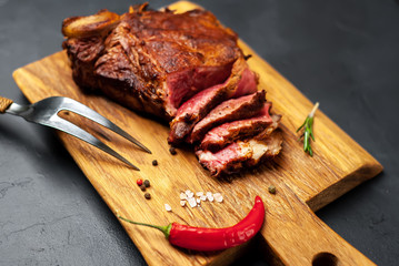 delicious steak, seasonings, a delicious piece of meat, cooked dinner on a concrete background