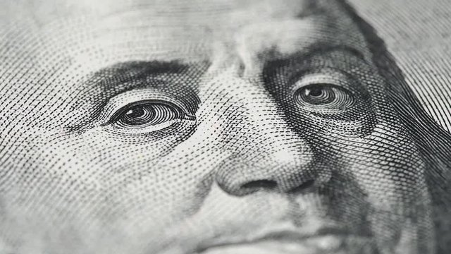 Benjamin Franklin on US 100 dollar bill macro slow rotating. Low angle shot. Stock video footage