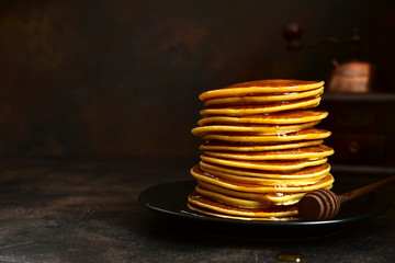 Homemade pancakes with honey or maple syrup.