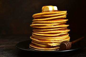 Homemade pancakes with honey or maple syrup.