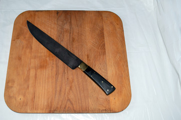 A hand made chef knife displayed on a wooden cutting board. An asset for any kitchen or restaurant...