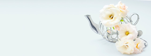 Decorative tea pot with white coral roses