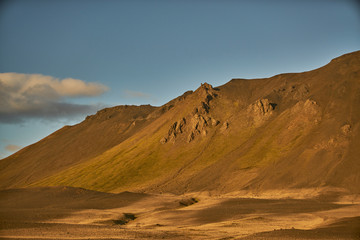Fototapeta na wymiar Dali landscape, sunset with golden mountains and blue sky no. 1