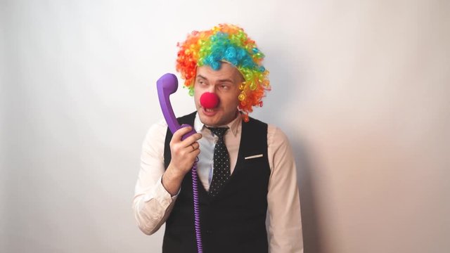 Office worker in clown wig, clown concept at work. Businessman with clown wig isolated on white