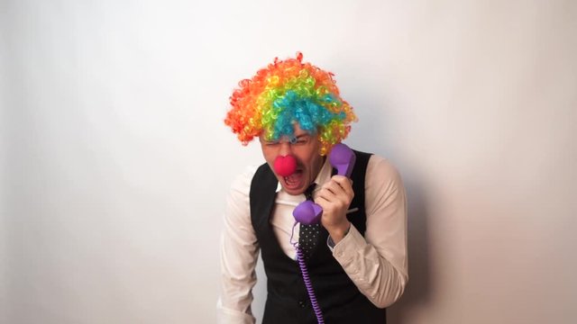 Office worker in clown wig, clown concept at work. Businessman with clown wig isolated on white