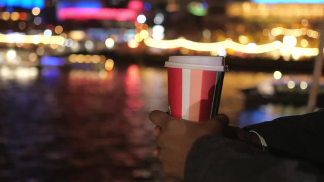 Cup of coffee at night in the colorful city of London