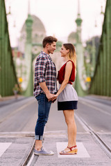 Young loving couple hugging in the street.