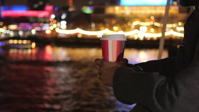 Cup of coffee at night in the colorful city of London