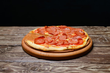 Pepperoni pizza on wooden table