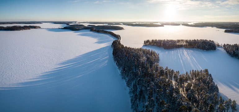 Aerial winter landscape panorama of ridge road in Punkaharju, Finland.