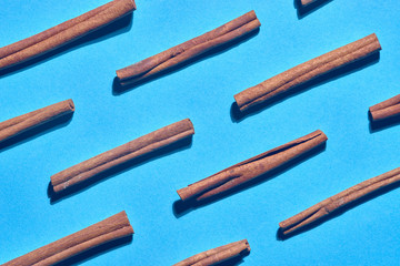 cinnamon sticks on color background