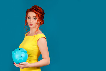 jealous woman looking over her shoulder holding piggy