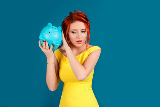 Worried Woman With Empty Piggy Bank