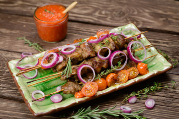 Fototapeta na wymiar Grilled meat skewers, shish kebab on wood background, top view 