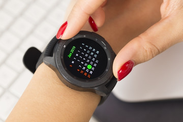 Woman checking appointments and reminders from calendar on smart watch