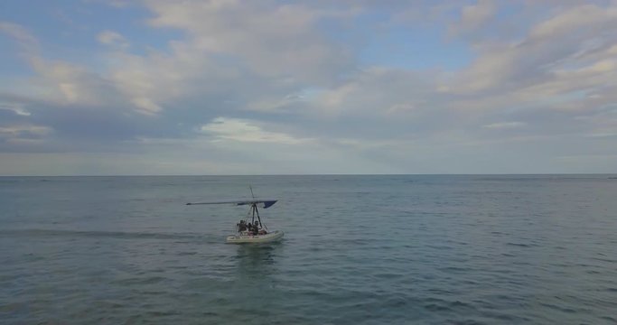 FIB - Flying Inflatable Boat. Aerial shot following the Amphibious Aircraft Sailing in the Caribbean Sea just before Taking Off in the Sky