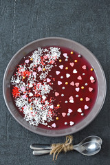 Breakfast or dessert for Valentine's Day. Red marmalade bowl with sweet hearts and decorations. Romantic healthy food.