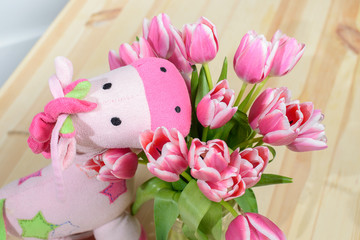  Pink tulips and soft toy on a pink background