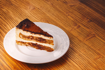 Delicious piece of cake on the wooden table