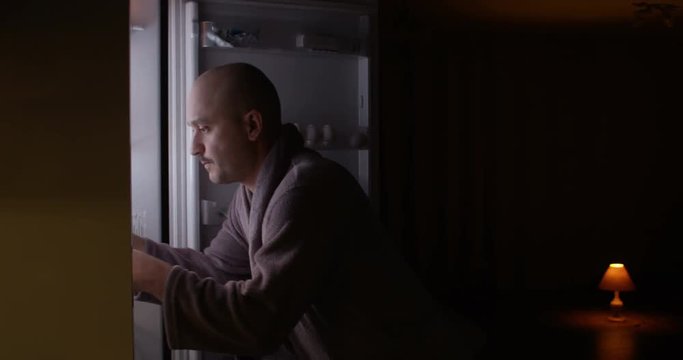 Hungry Man Looking in a Fridge Taking Plate with Food at Night Funny Behaving Shot on Red Epic