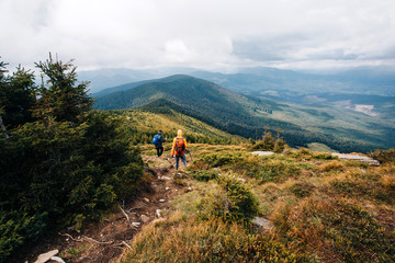 Obraz premium Two persons wandering in the woods and the mountains 