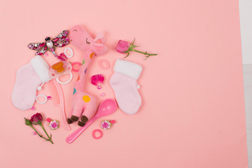  Baby things and accessories on a pink background