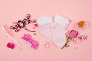  Baby things and accessories on a pink background