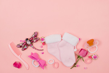  Baby things and accessories on a pink background