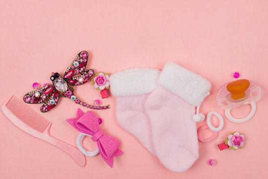 Baby things and accessories on a pink background