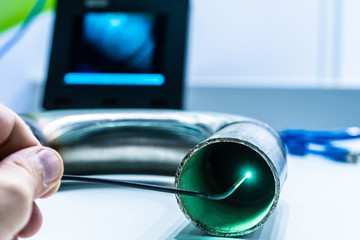 A man controls a video endoscope. Quality control of metal welding. Check weld. Video...