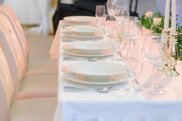 Wedding table place setting, plates and glasses