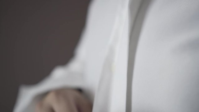 a man who bucks buttons on his suit