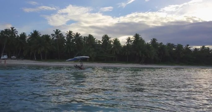 FIB - Flying Inflatable Boat. Aerial shot tracking the amphibious aircraft sailing in the sea.