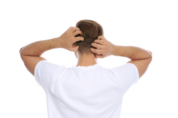 Young man scratching head on white background. Annoying itch