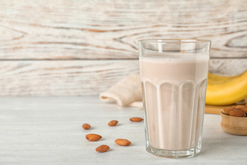 Composition with glass of healthy protein shake on table. Space for text