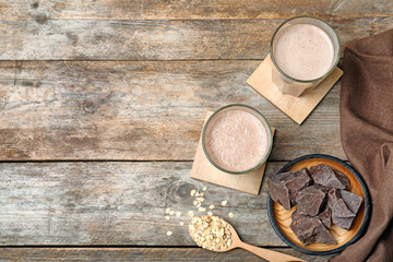 Obraz na płótnie Canvas Flat lay composition with healthy protein shake, ingredients and space for text on wooden background
