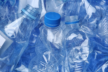 Pile of crumpled plastic bottles as background, closeup. Recycling problem