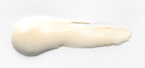 Abstract brushstroke of white paint isolated on white