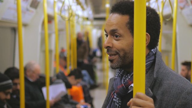 African businessman in a London underground train