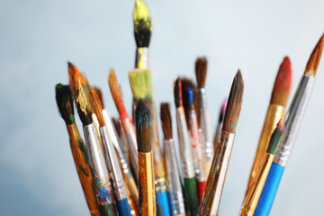 Obraz premium Different paint brushes on light background, closeup