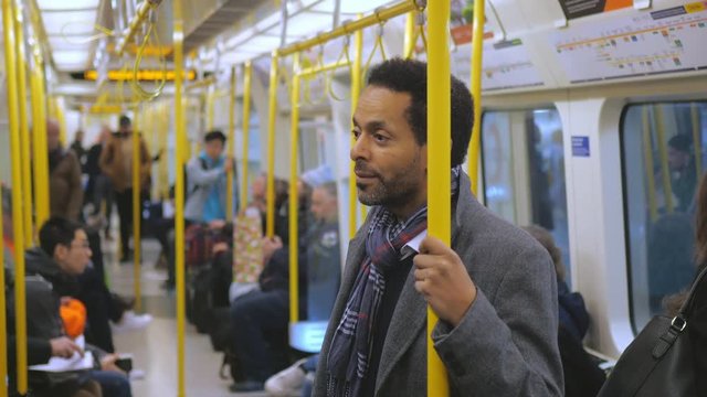 Black businessman in a London underground coach